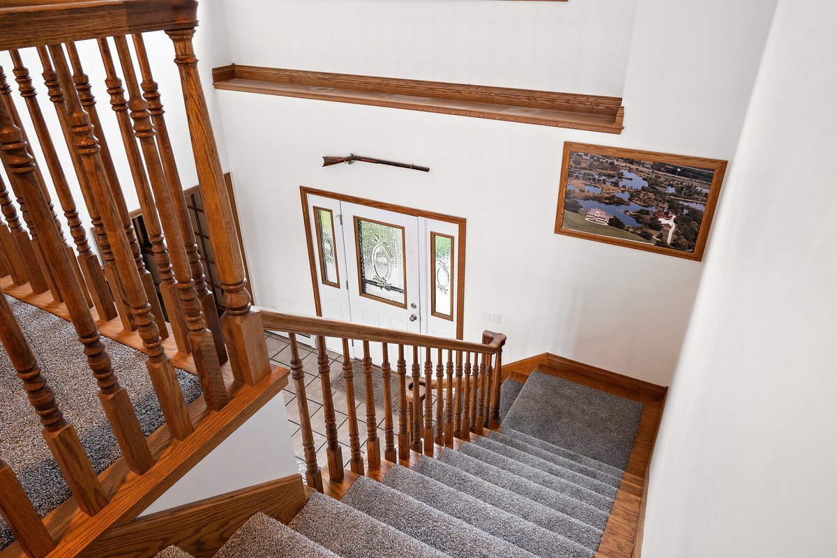 10739-451 North 1300 E Road Chenoa, IL 61726 - Photo 25 of 55 a view of a hallway with wooden floor and staircase