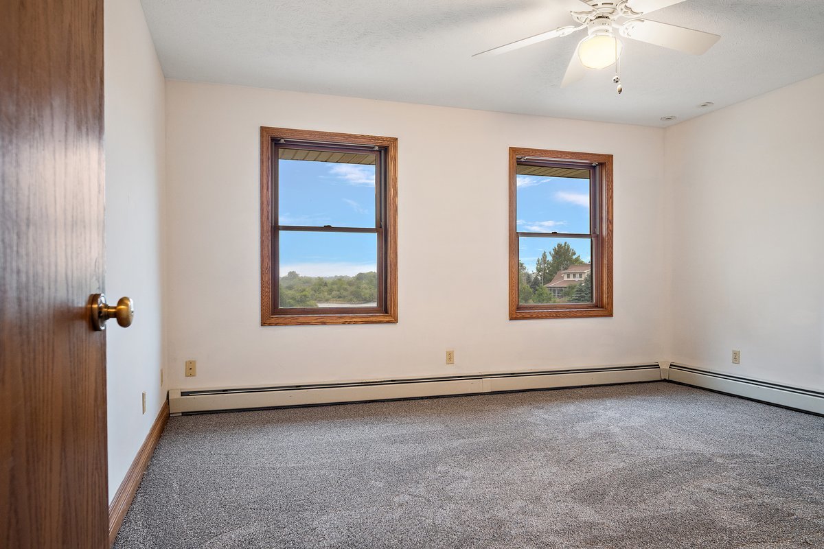 10739-451 North 1300 E Road Chenoa, IL 61726 - Photo 29 of 55 an empty room with windows and fan
