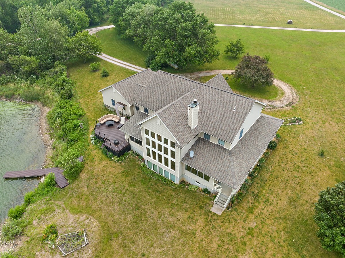 10739-451 North 1300 E Road Chenoa, IL 61726 - Photo 42 of 55 an aerial view of a house with swimming pool and large trees
