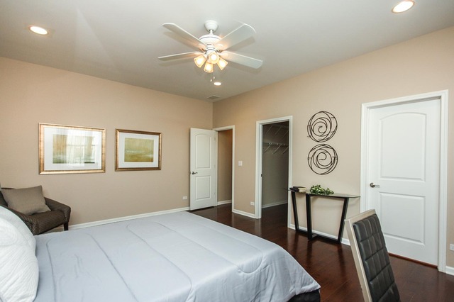 4115 South Drexel Boulevard, Unit 2F Chicago, IL 60653 - Photo 11 of 17 a bedroom with a bed and a chandelier