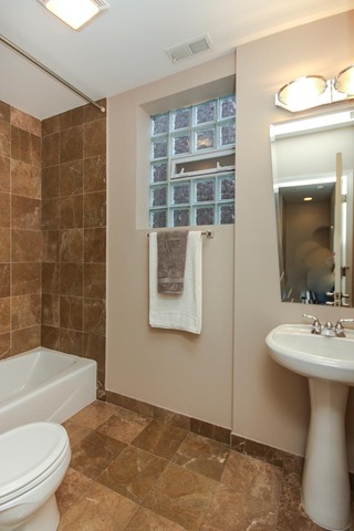4115 South Drexel Boulevard, Unit 2F Chicago, IL 60653 - Photo 14 of 17 a bathroom with a sink a toilet and bathtub