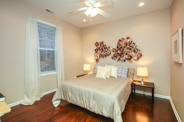 4115 South Drexel Boulevard, Unit 2F Chicago, IL 60653 - Photo 16 of 17 a bedroom with a bed and a chandelier