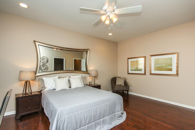 4115 South Drexel Boulevard, Unit 2F Chicago, IL 60653 - Photo 17 of 17 a bedroom with a bed and wooden floor