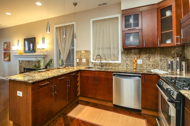 4115 South Drexel Boulevard, Unit 2F Chicago, IL 60653 - Photo 9 of 17 a kitchen with stainless steel appliances granite countertop a sink stove and cabinets