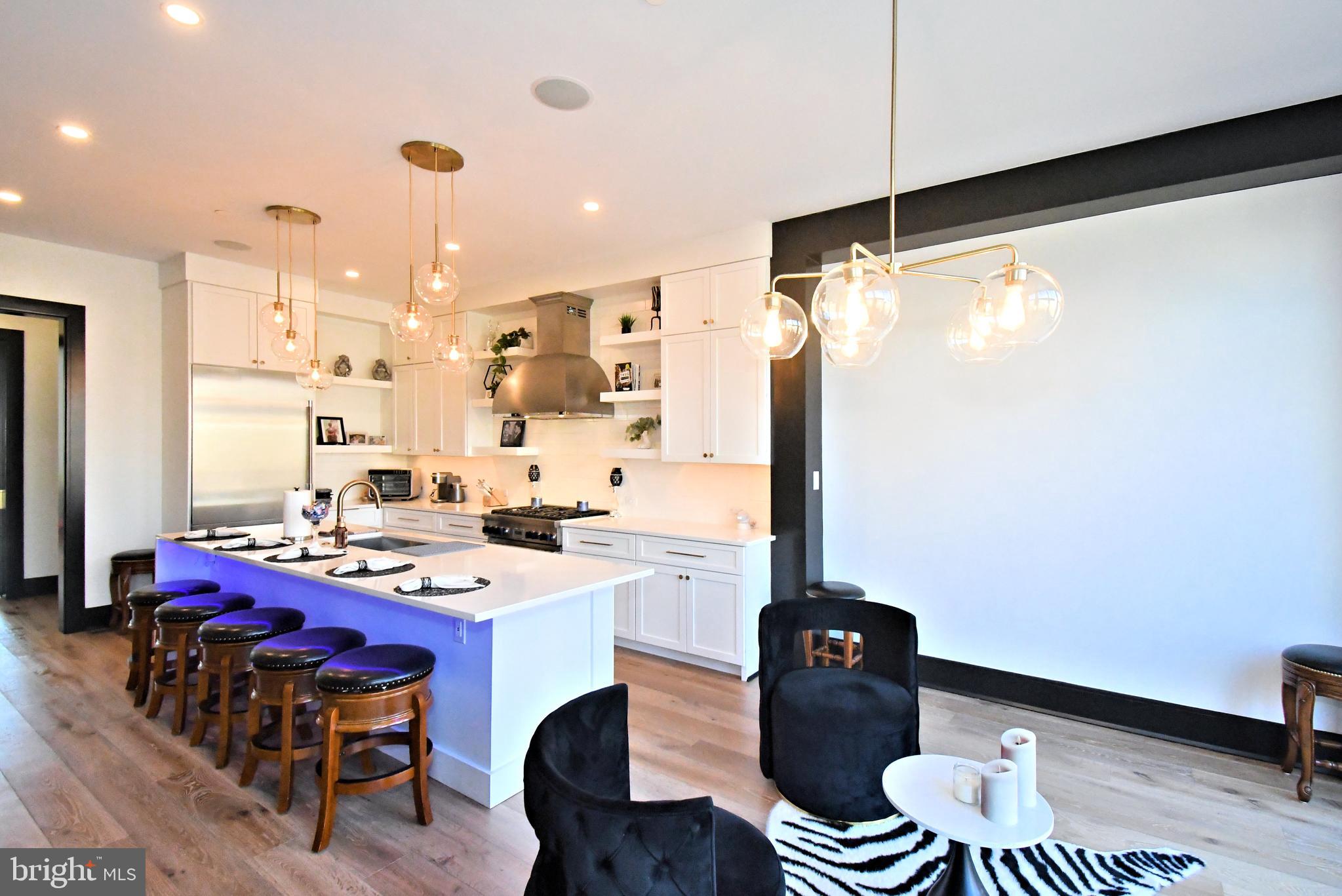 10 Richards Way Ambler, PA 19002 - Photo 18 of 73 a kitchen with a table chairs stove and white cabinets