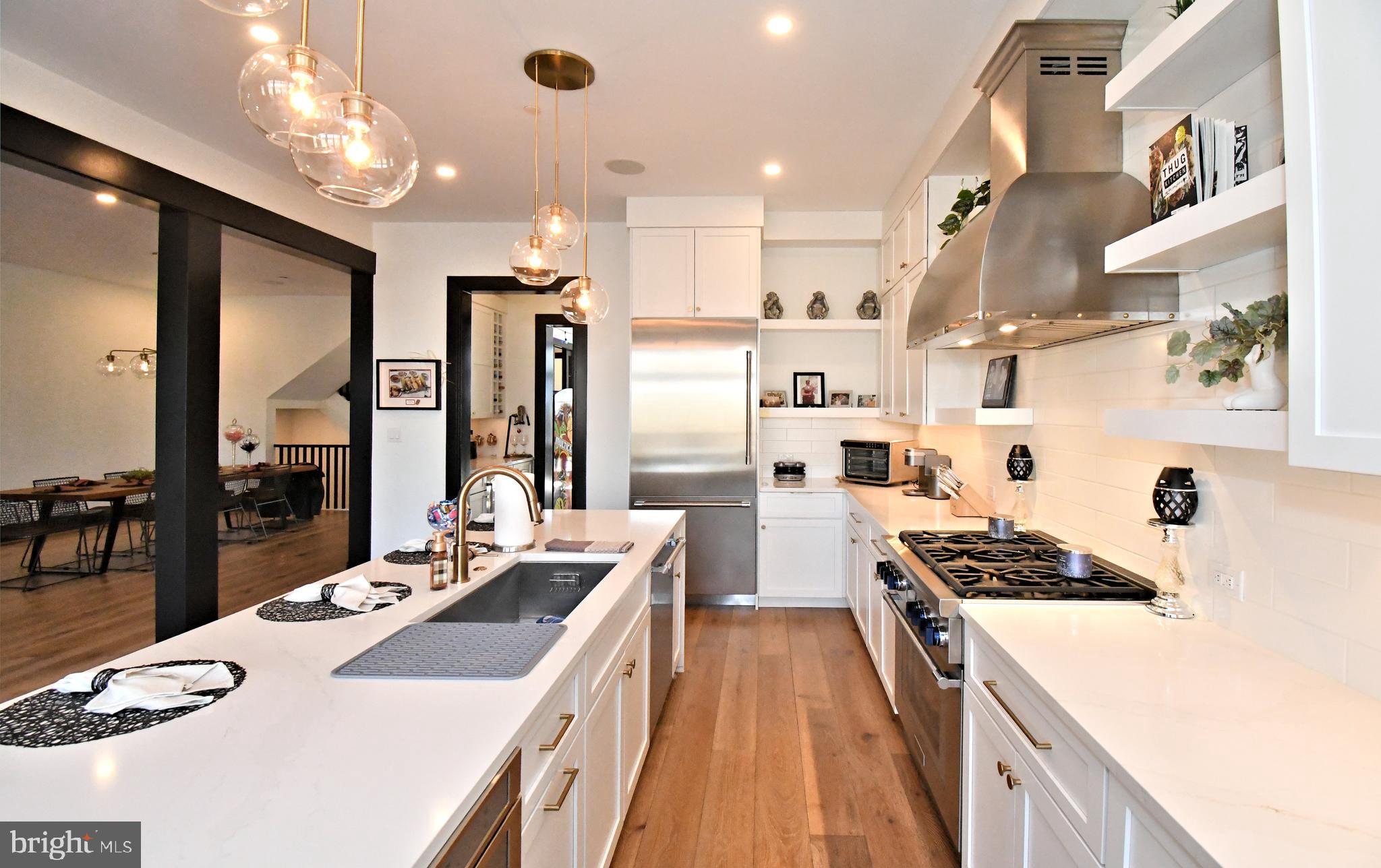 10 Richards Way Ambler, PA 19002 - Photo 22 of 73 a kitchen with stainless steel appliances a stove a sink dishwasher a refrigerator white cabinets and couches with wooden floor