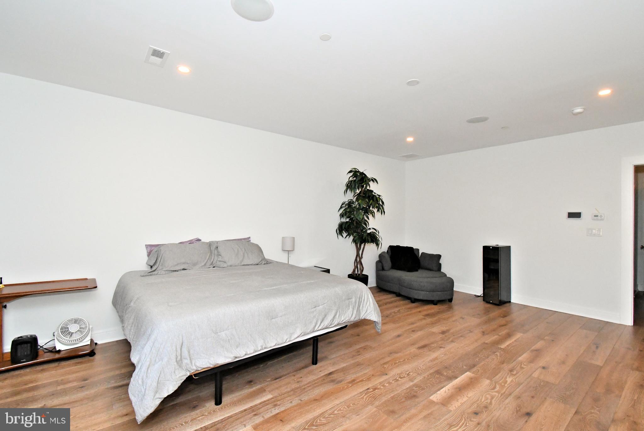 10 Richards Way Ambler, PA 19002 - Photo 34 of 73 a bedroom with a bed and wooden floor