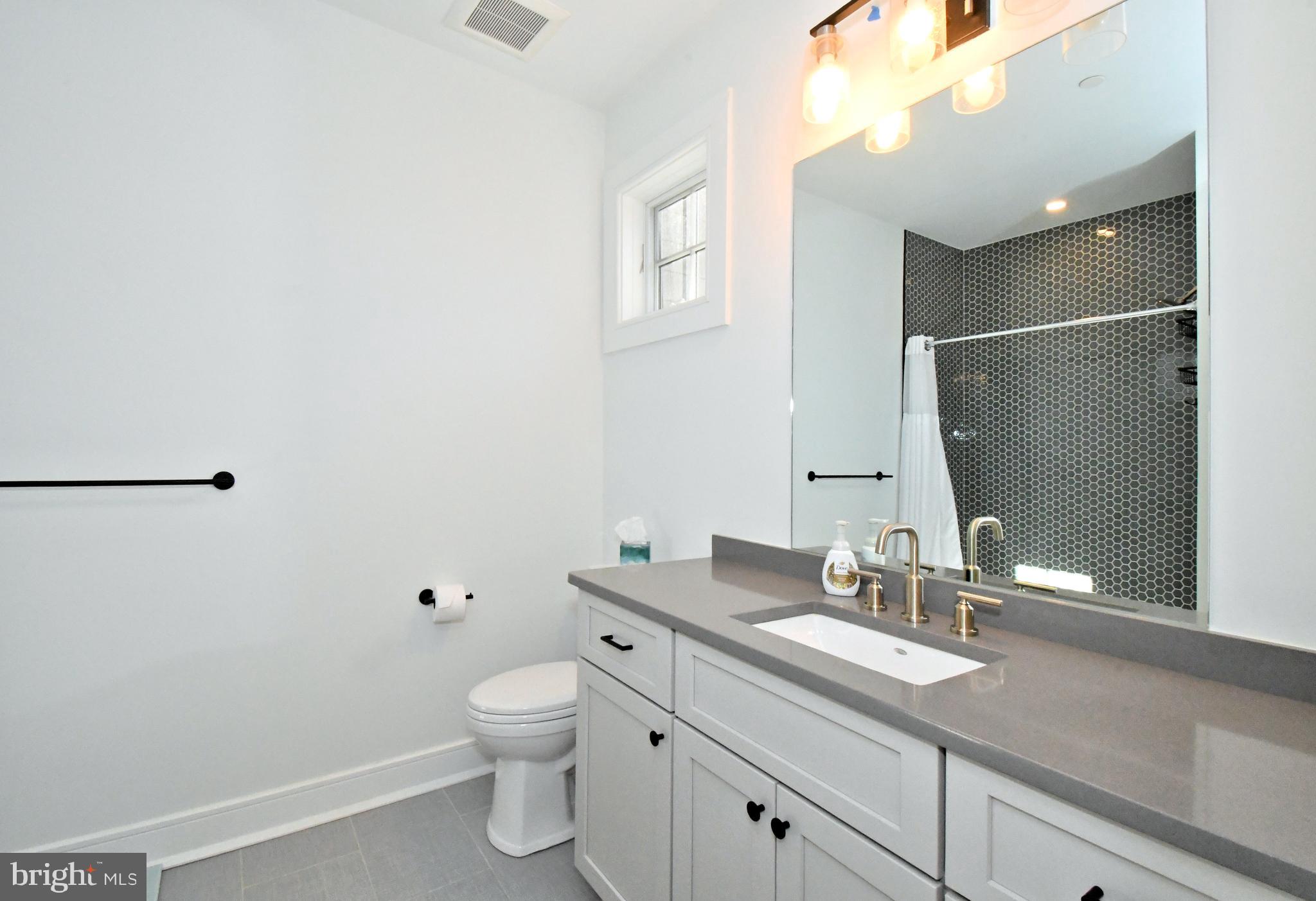 10 Richards Way Ambler, PA 19002 - Photo 50 of 73 a bathroom with a granite countertop sink a toilet and a mirror
