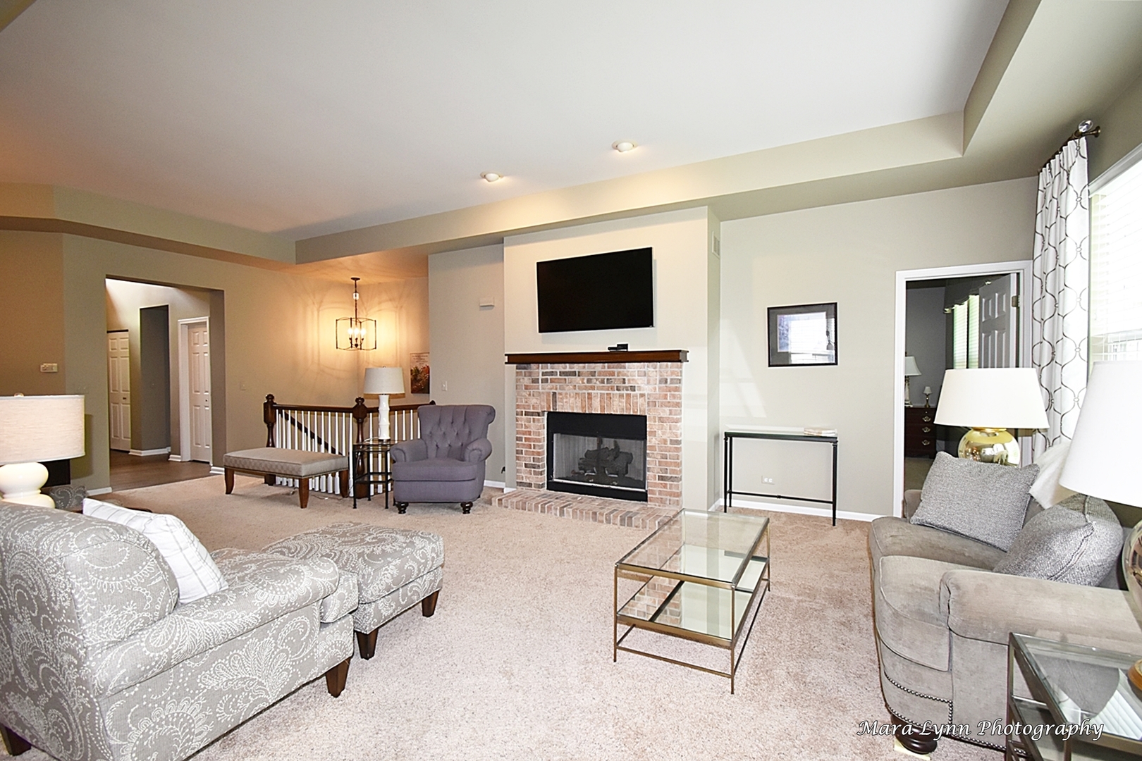 714 Viewpointe Drive St. Charles, IL 60174 - Photo 5 of 31 a living room with furniture a fireplace and a flat screen tv