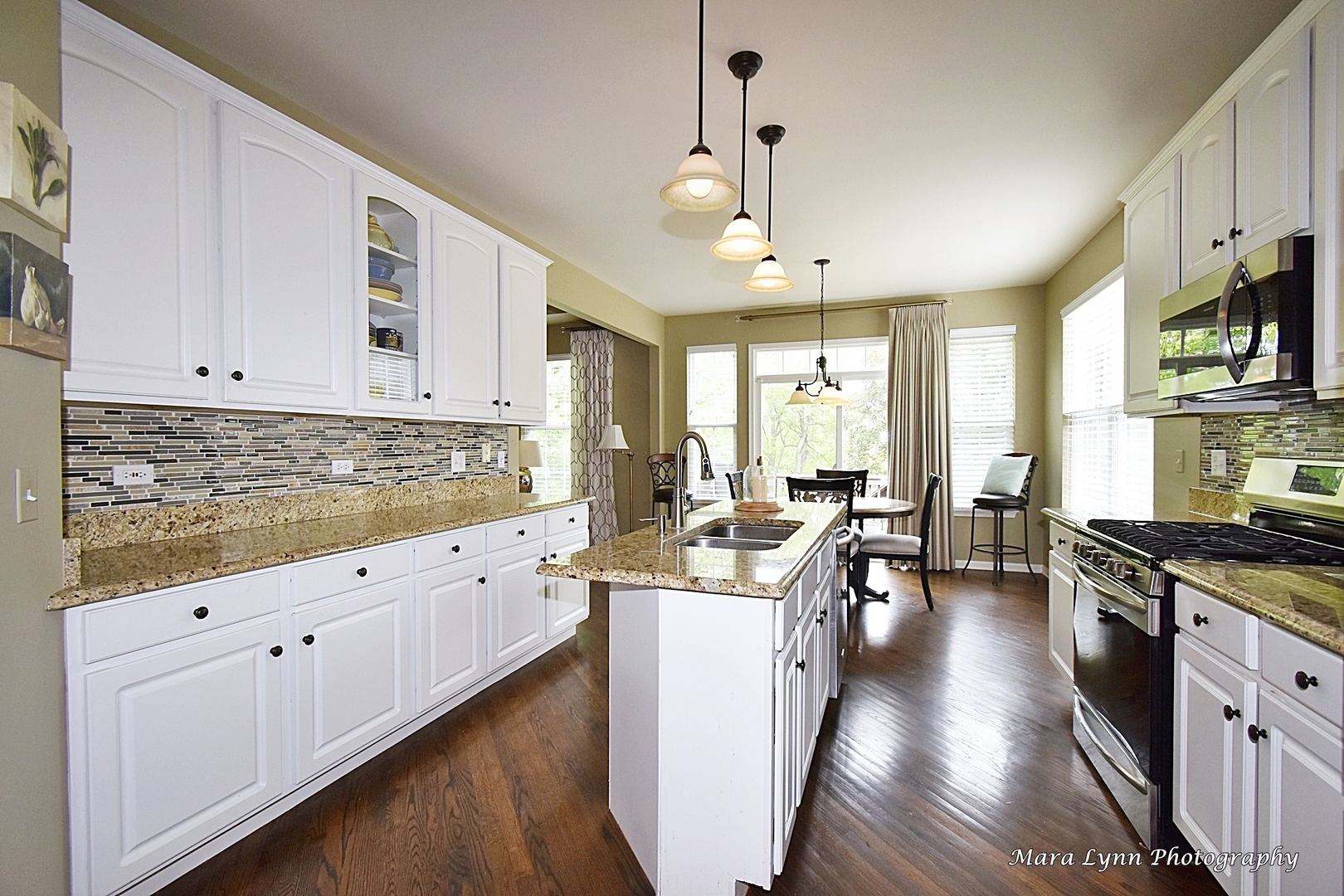 714 Viewpointe Drive St. Charles, IL 60174 - Photo 9 of 31 a kitchen with stainless steel appliances granite countertop a stove top oven a sink dishwasher and white cabinets with wooden floor