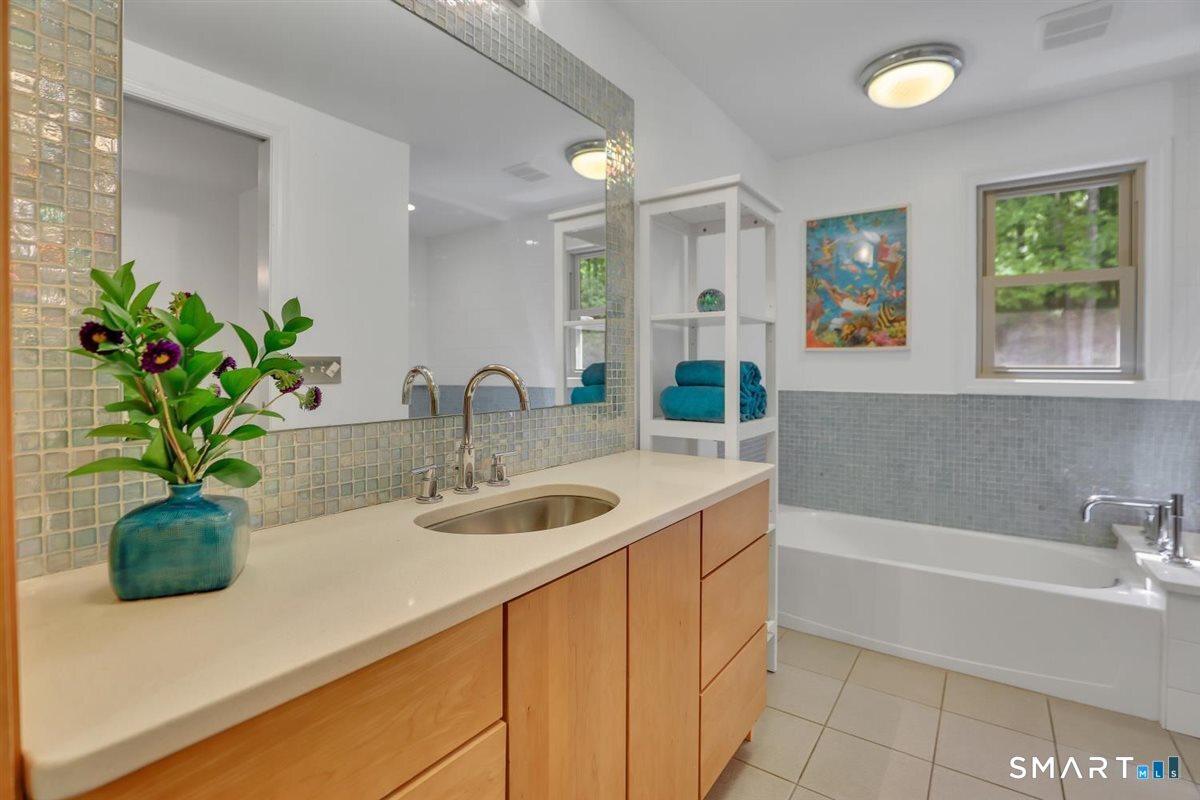122 Ridgeview Circle Guilford, CT 06437 - Photo 20 of 40 Designer tile accent on walls and surrounding the tub and walk-in shower.