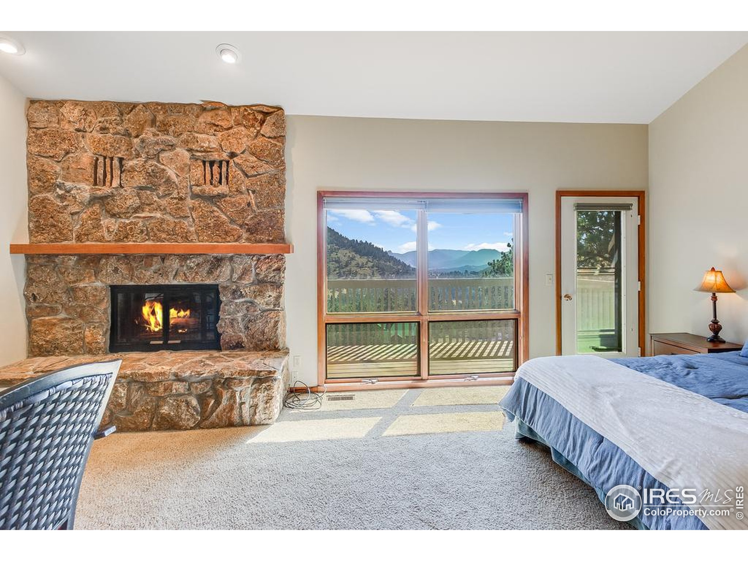 1070 Crestview Court, Unit 4 Estes Park, CO 80517 - Photo 15 of 28 a bedroom with a bed and a fireplace