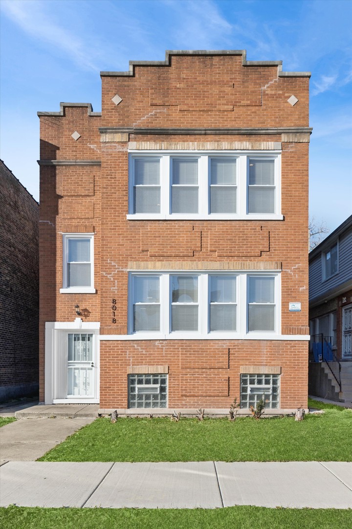 8018 South Harvard Avenue, Unit 2 Chicago, IL 60620 - Photo 1 of 14 a front view of a building with a garden