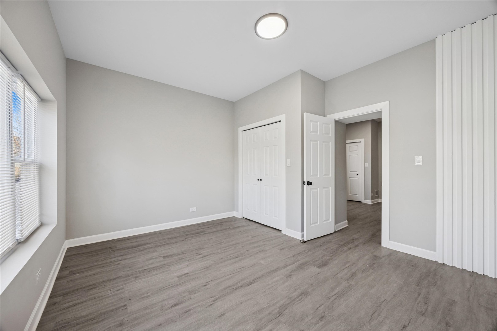 8018 South Harvard Avenue, Unit 2 Chicago, IL 60620 - Photo 14 of 14 an empty room with wooden floor and windows