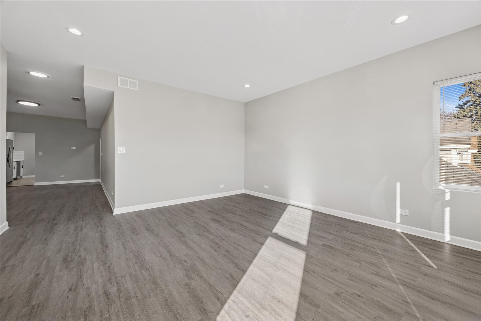 8018 South Harvard Avenue, Unit 2 Chicago, IL 60620 - Photo 6 of 14 an empty room with wooden floor and windows