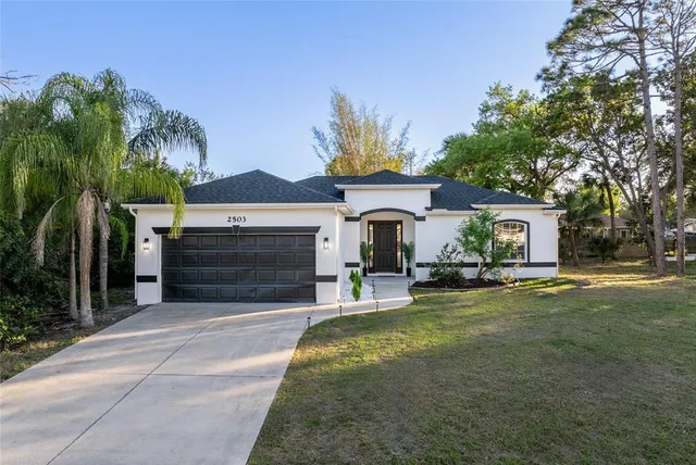 a view of house with outdoor space and swimming pool