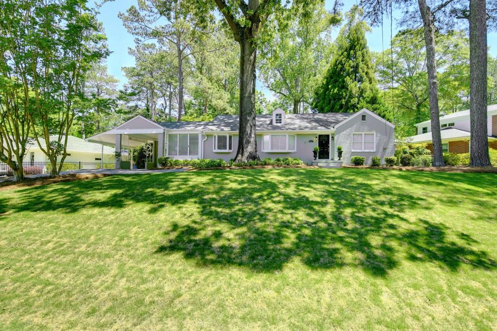2001 Lenox Road Northeast Atlanta, GA 30306 - Photo 1 of 1 a front view of a house with a garden