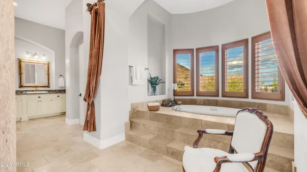 a bathroom with a granite countertop sink a mirror and shower
