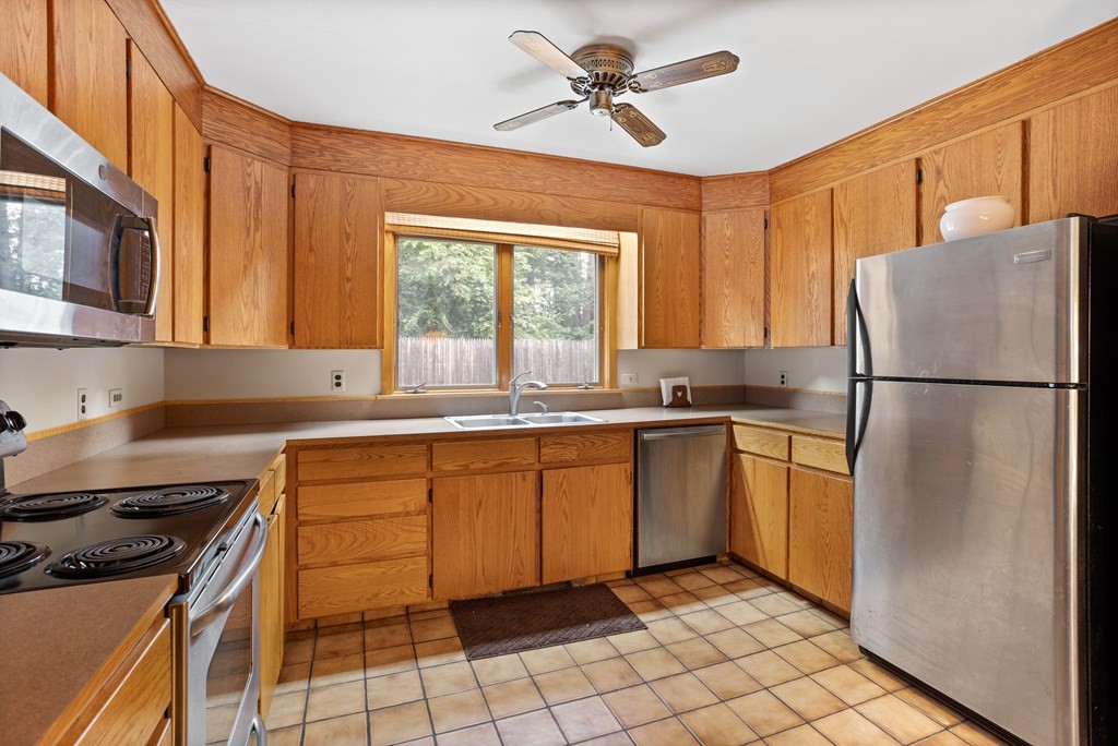 110 Middle Road Boxborough, MA 01719 - Photo 22 of 33 a kitchen with a refrigerator a stove a sink and a window