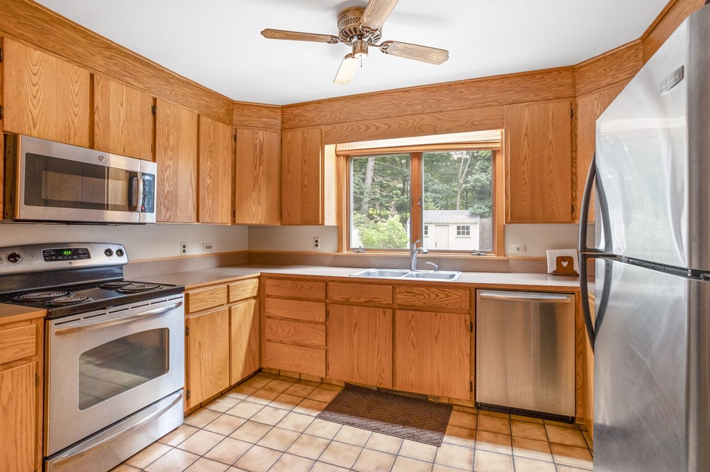 110 Middle Road Boxborough, MA 01719 - Photo 23 of 33 a kitchen with stainless steel appliances granite countertop a stove a sink and a microwave