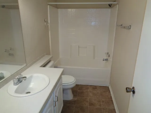 a white bath tub sitting next to a toilet