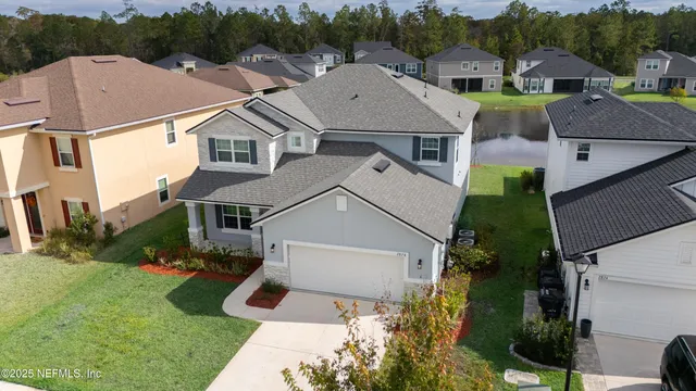 an aerial view of houses with yard