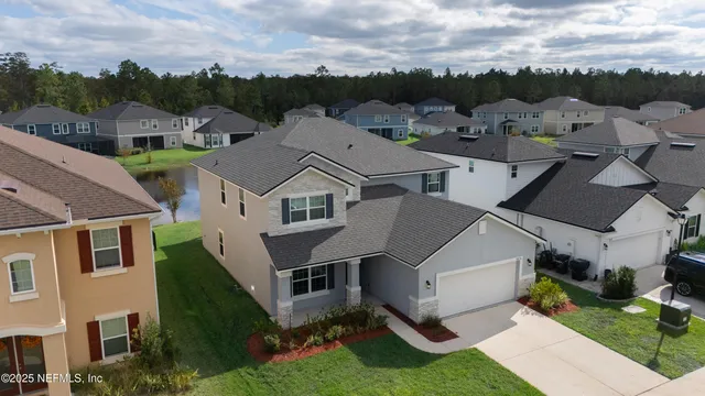 a aerial view of a house with a yard