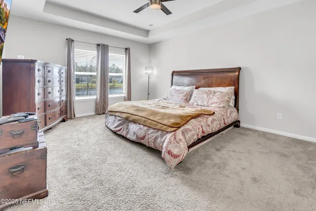 a spacious bedroom with a bed and large window