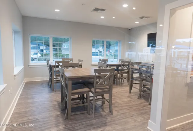 a view of a dining room with furniture and wooden floor