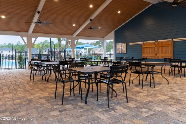 a outdoor space with furniture a large window and a projector