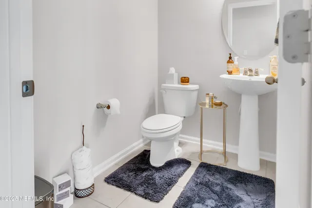 a bathroom with a toilet a sink and a mirror