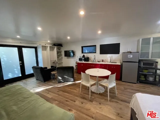 a living room with furniture a dining table and kitchen view