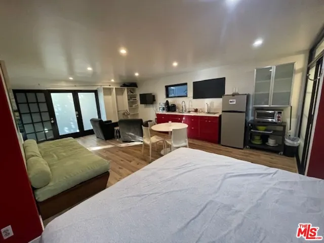 a large bedroom with a bed and furniture