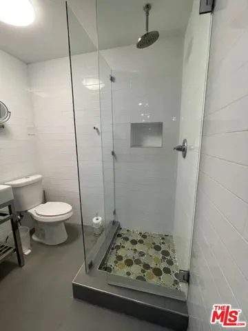 a bathroom with a toilet and a shower