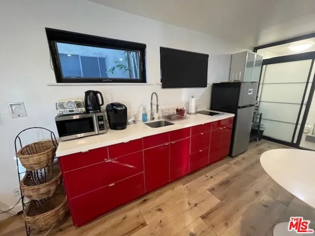 a kitchen with a sink cabinets and appliances