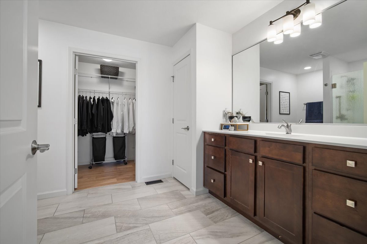 1423 Pine Forest Drive Normal, IL 61761 - Photo 16 of 23 a spacious bathroom with a double vanity sink a large mirror and a shower