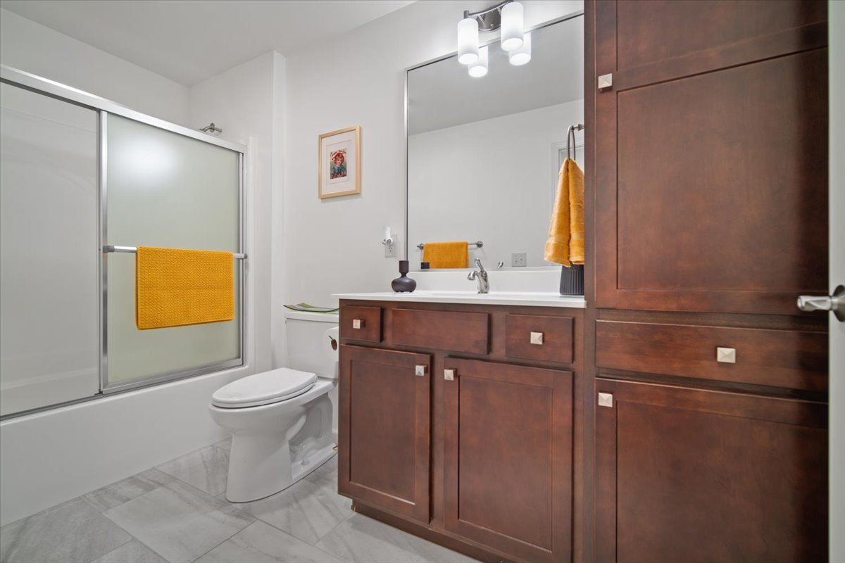 1423 Pine Forest Drive Normal, IL 61761 - Photo 19 of 23 a bathroom with a sink a toilet and mirror