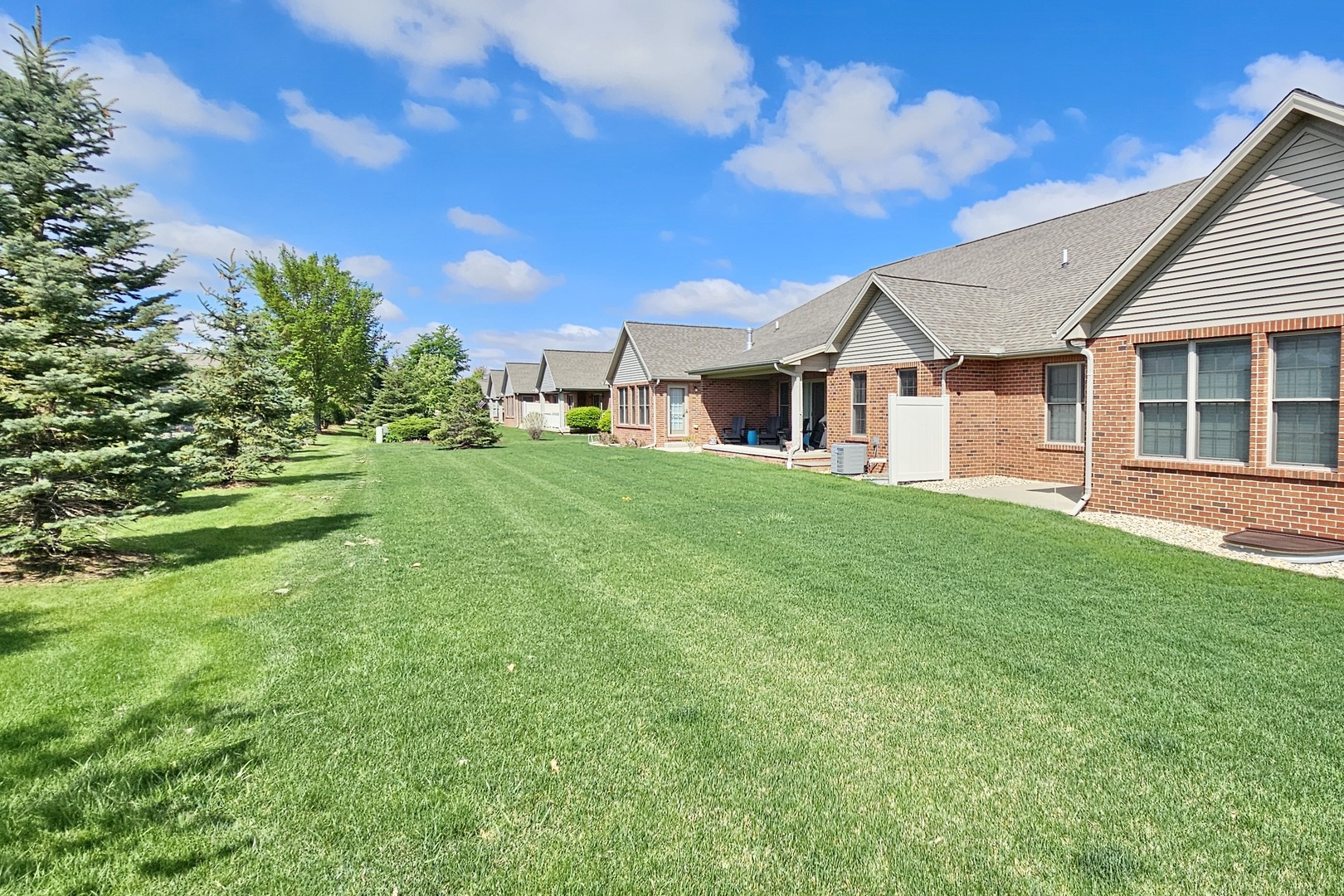 1423 Pine Forest Drive Normal, IL 61761 - Photo 2 of 23 a view of a yard in front of a house with large trees