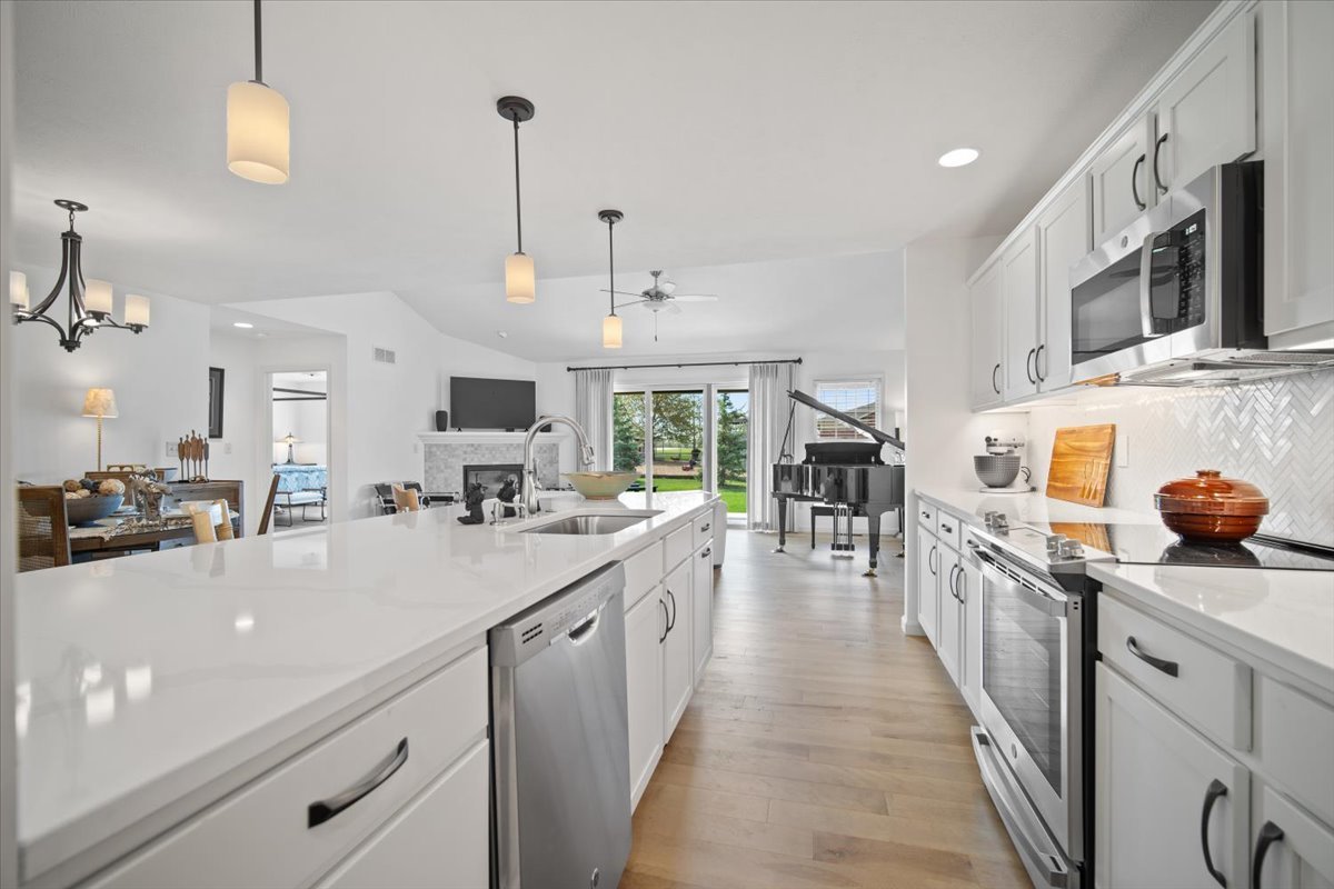 1423 Pine Forest Drive Normal, IL 61761 - Photo 5 of 23 a kitchen with stainless steel appliances kitchen island granite countertop a sink and cabinets