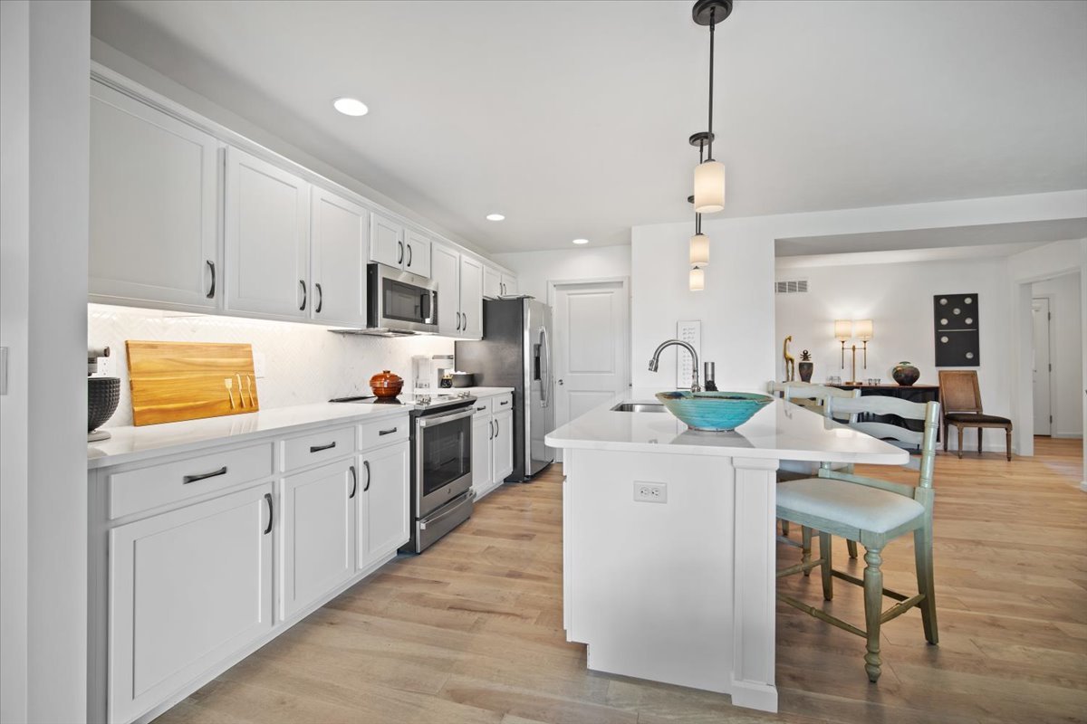 1423 Pine Forest Drive Normal, IL 61761 - Photo 6 of 23 a kitchen with white cabinets and stainless steel appliances