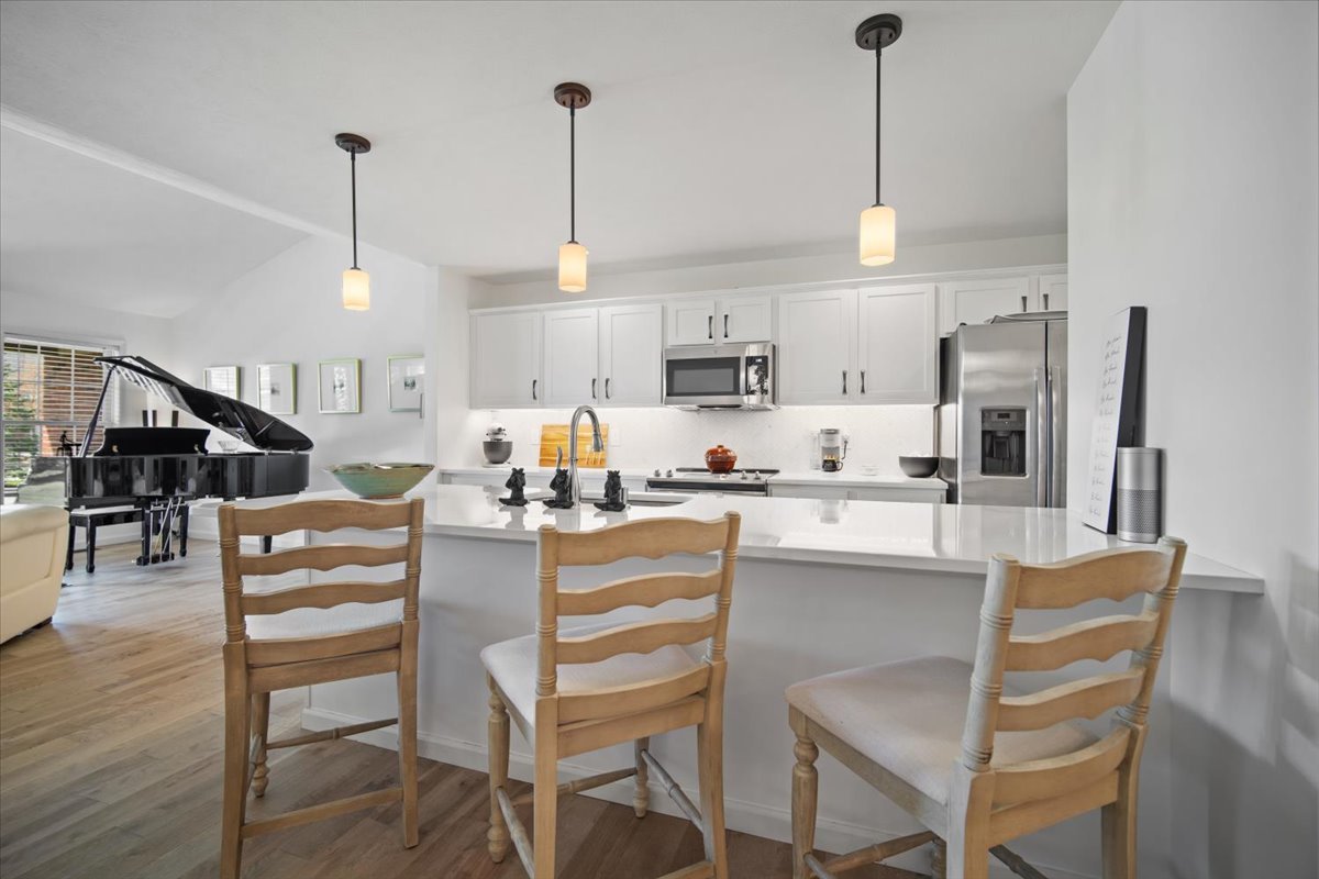 1423 Pine Forest Drive Normal, IL 61761 - Photo 8 of 23 a kitchen with stainless steel appliances granite countertop a stove top oven a refrigerator a sink and a wooden floor