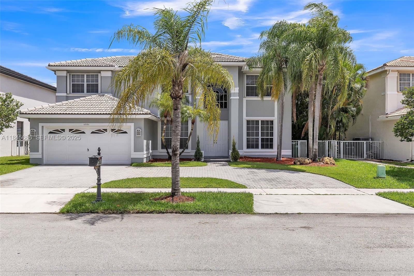 18091 Southwest 22nd Street Miramar, FL 33029 - Photo 1 of 41 a view of a white house with a small yard and plants