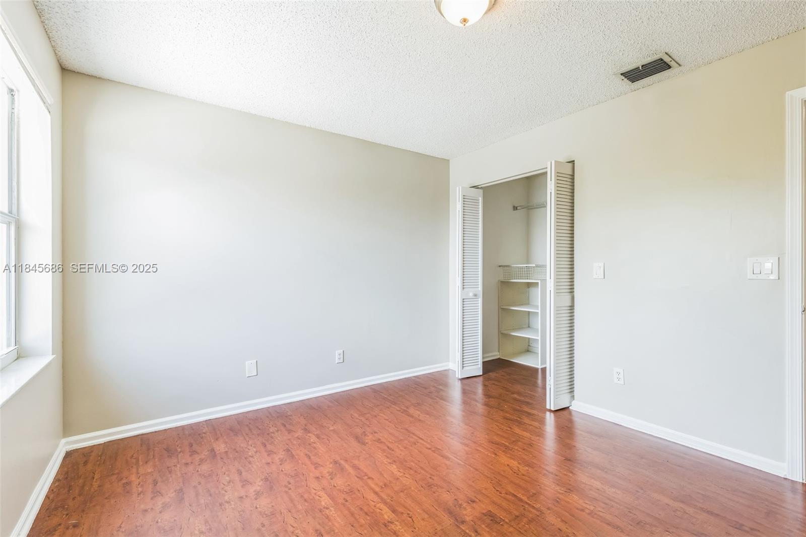 18091 Southwest 22nd Street Miramar, FL 33029 - Photo 11 of 41 a view of an empty room with wooden floor