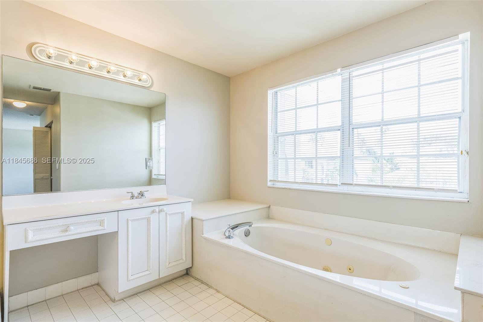 18091 Southwest 22nd Street Miramar, FL 33029 - Photo 17 of 41 a bathroom with a bathtub a bath tub and a sink