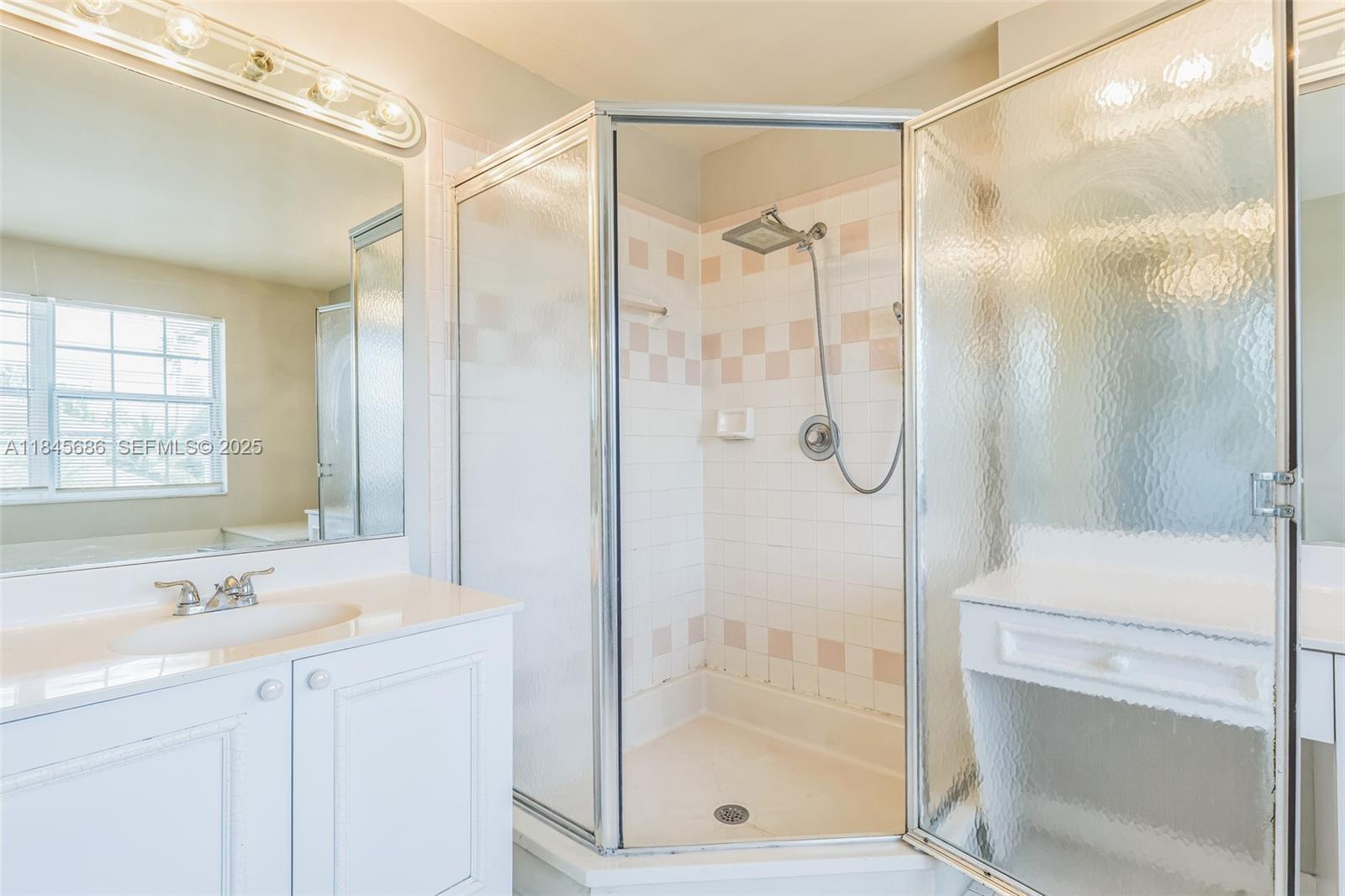 18091 Southwest 22nd Street Miramar, FL 33029 - Photo 18 of 41 a bathroom with a shower sink and mirror