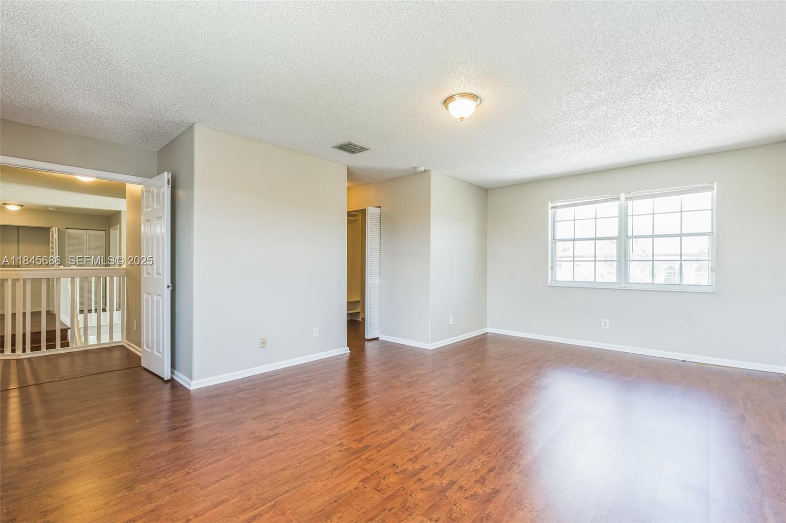 18091 Southwest 22nd Street Miramar, FL 33029 - Photo 25 of 41 an empty room with wooden floor and windows