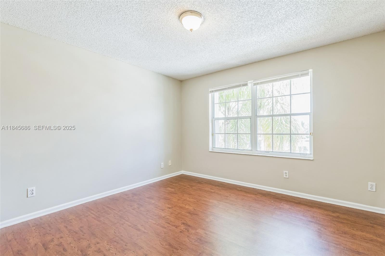 18091 Southwest 22nd Street Miramar, FL 33029 - Photo 27 of 41 an empty room with wooden floor and windows