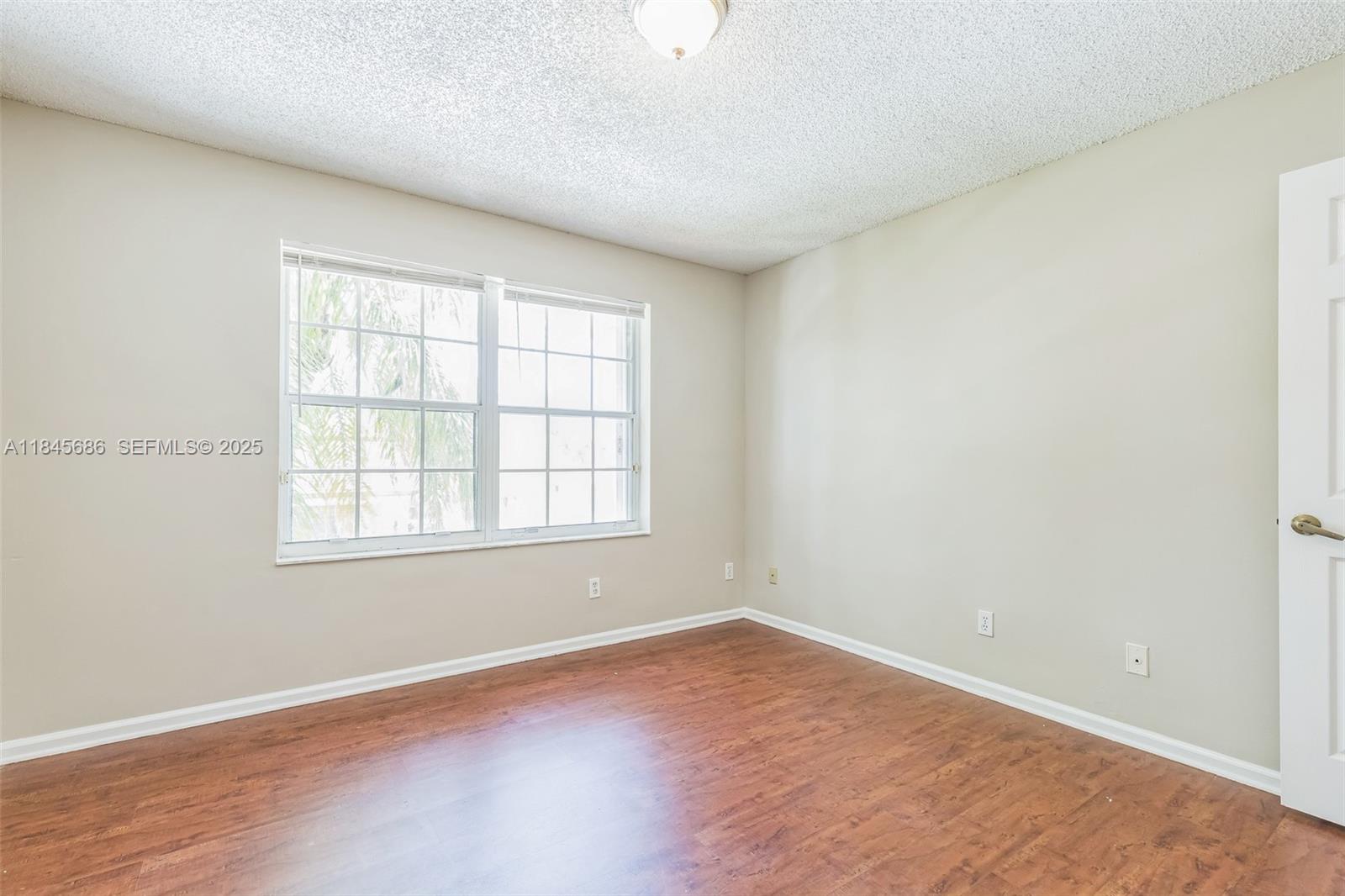 18091 Southwest 22nd Street Miramar, FL 33029 - Photo 28 of 41 an empty room with wooden floor and windows