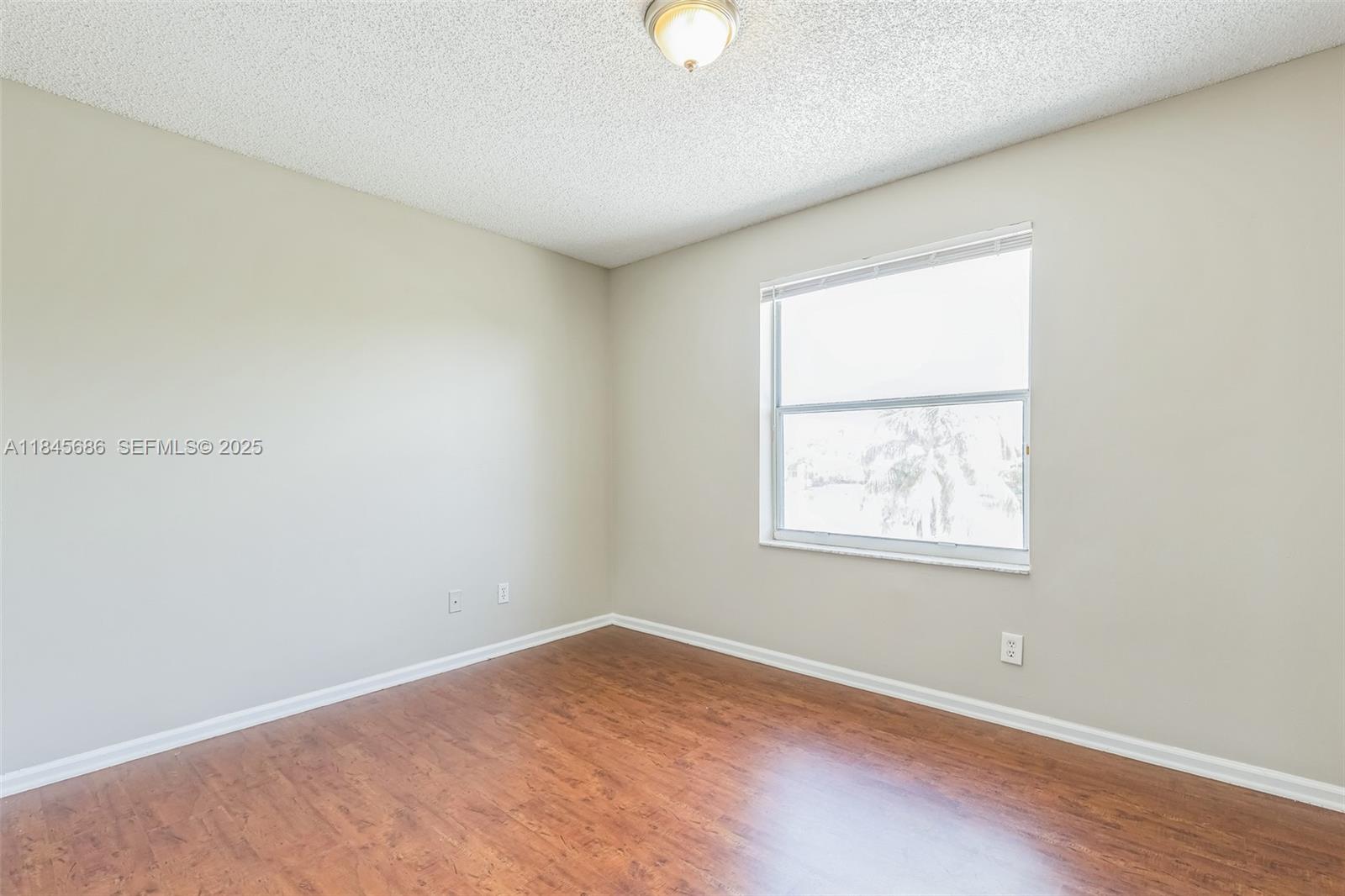 18091 Southwest 22nd Street Miramar, FL 33029 - Photo 30 of 41 an empty room with wooden floor and windows
