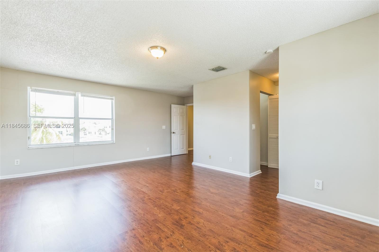 18091 Southwest 22nd Street Miramar, FL 33029 - Photo 34 of 41 an empty room with wooden floor and windows